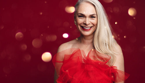 Attractive senior woman with glitters falling around