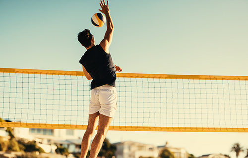 Pro athlete soars through the sky in summer beach volleyball championship