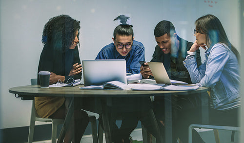 Multiracial group of young students using phones