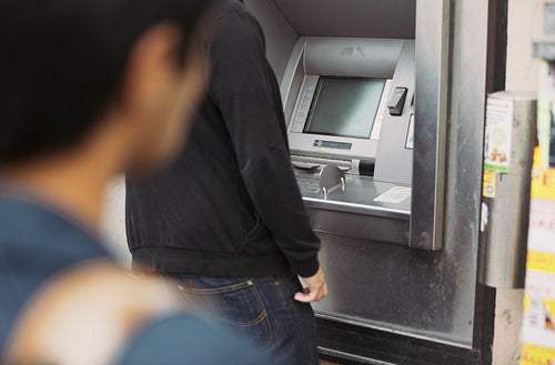 Thief folloing victim using a bank atm machine