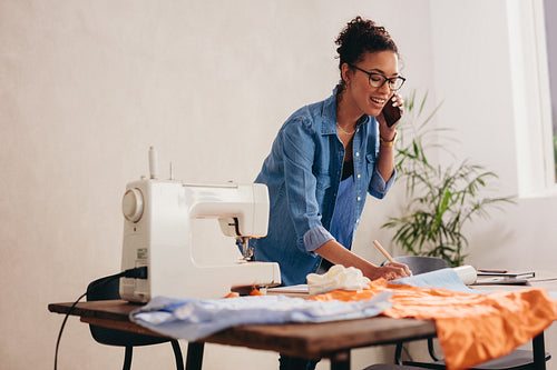 Tailor talking order on phone