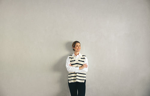 Cheerful businesswoman looking away with a smile in an office