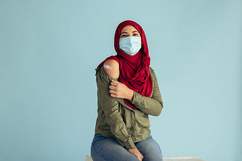 Vaccinated woman in face mask