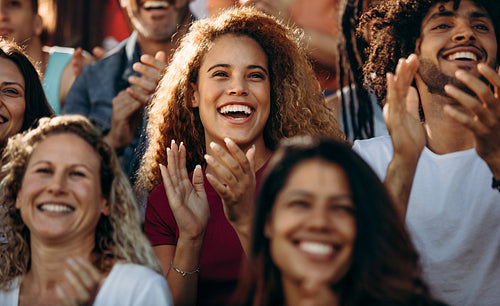 Excited sports fans applauding for their team