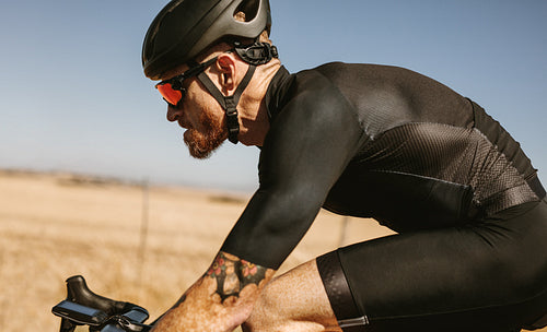 Professional cyclist riding bike outdoors