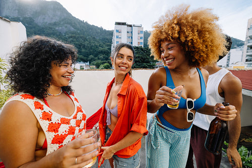 Cheerful friends enjoying a rooftop gathering in Rio de Janeiro
