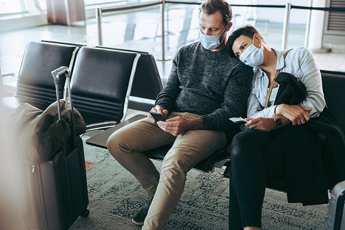 Couple waiting for delayed flight during pandemic lockdown