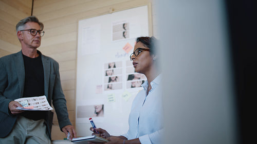 Happy colleagues brainstorming in office