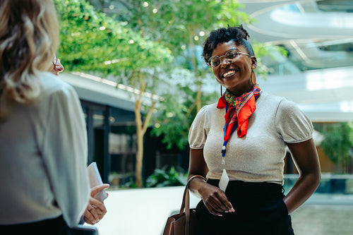 Confident financial analyst smiling during a business meeting in a modern office environment