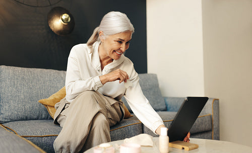 Senior freelancer connecting with her work clients on a video call from her home office