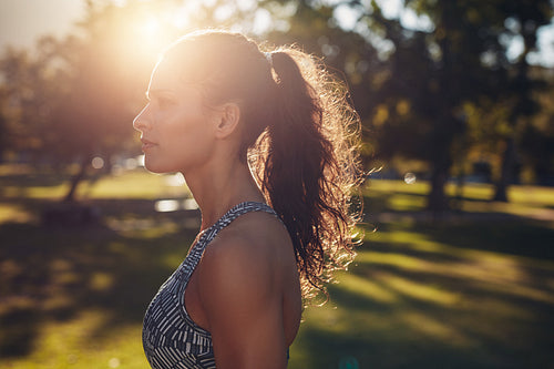 Fit young woman standing at the park