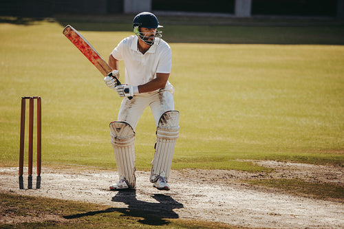 Male cricket player ready to bat at the crease during a match