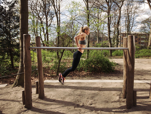 Fitness female doing parallel bar dips