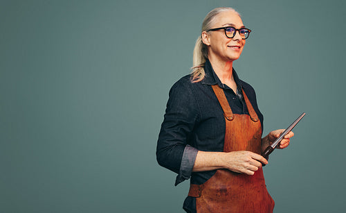 Goldsmith holding a ring mandrel in a studio