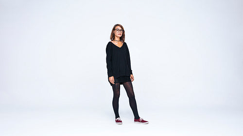 Young woman standing against white background