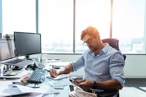 Businessman working at his desk in office.