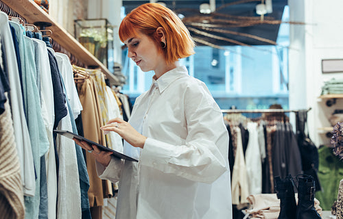 Fashion store owner checking the stock
