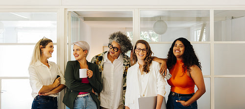 Happy businesswomen smiling while standing together