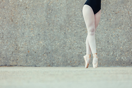 Closeup of legs of ballet dancer standing in pointes