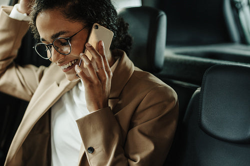 Businesswoman traveling to work and talking on phone