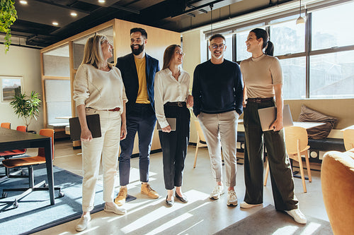 Group of colleagues smiling cheerfully in an office