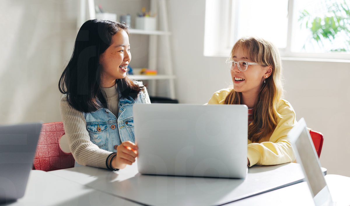 Two happy female students learning together in a coding class – Jacob ...