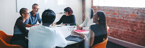 Smiling businesspeople sitting together in a meeting room