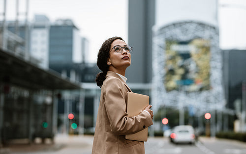 Businesswoman on city street with digital tablet