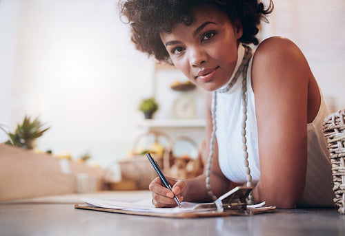 Beautiful young african woman working in a juice bar