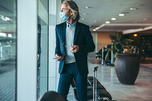 Businessman waiting for his flight in airport terminal