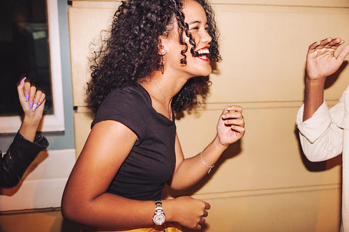 Happy young woman laughing joyfully outdoors