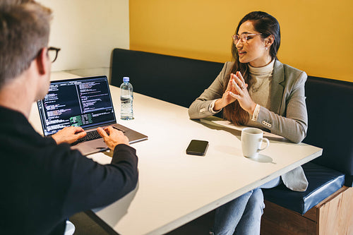 Coding in a cafe: Software developers working together on a remote tech project