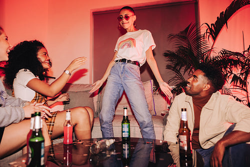 Young woman dancing for her friends at a house party