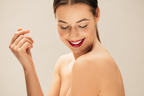 Pretty young woman posing topless