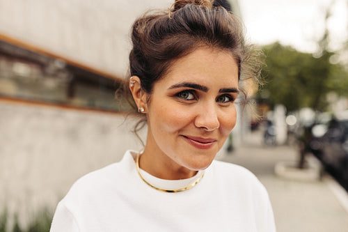 Carefree young woman looking at the camera in the city