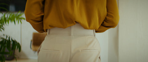 Woman walking into a modern office and working on laptop