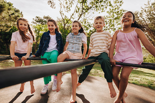 Group of Happy Children Playing Outdoors in a Park on a Sunny Day