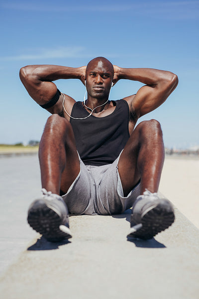 African fitness model exercising outdoors.