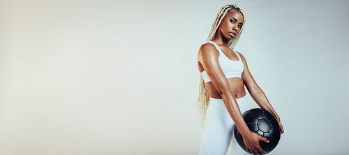 Fitness woman holding exercise ball