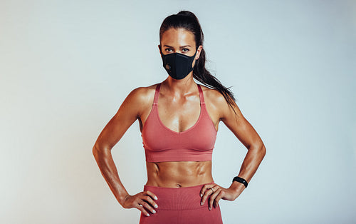 Woman with muscualr body wearing face mask