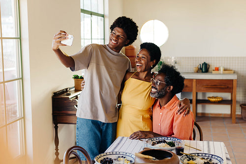 Family taking a selfie together at the dining table in a Brazilian home