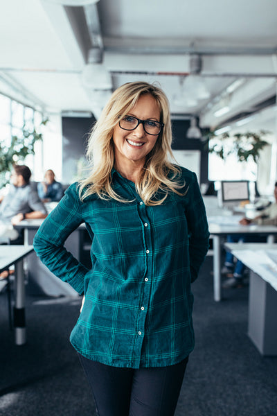 Smiling mature female standing in office