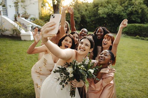 Women celebrating together taking a selfie at a garden wedding