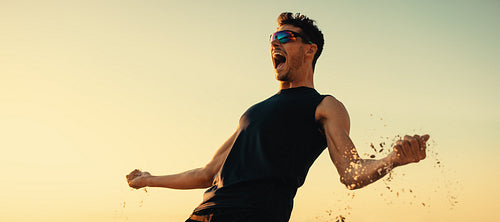 Victorious athlete celebrating victory at coastal beach volleyball championship