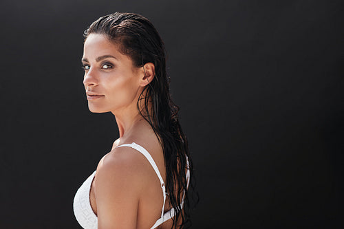 Fitness model standing on black background