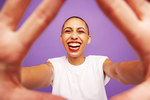 Portrait of a cheerful female with hands in front