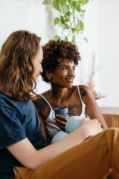 Intimate couple sharing a moment with coffee at home