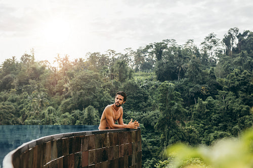 Caucasian man relaxing in swimming pool