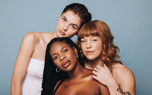 Women with different skin tones standing together