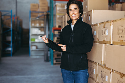 Mature warehouse manager smiling at the camera